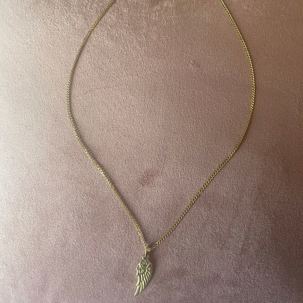 Gold color chain necklace with wing pendant